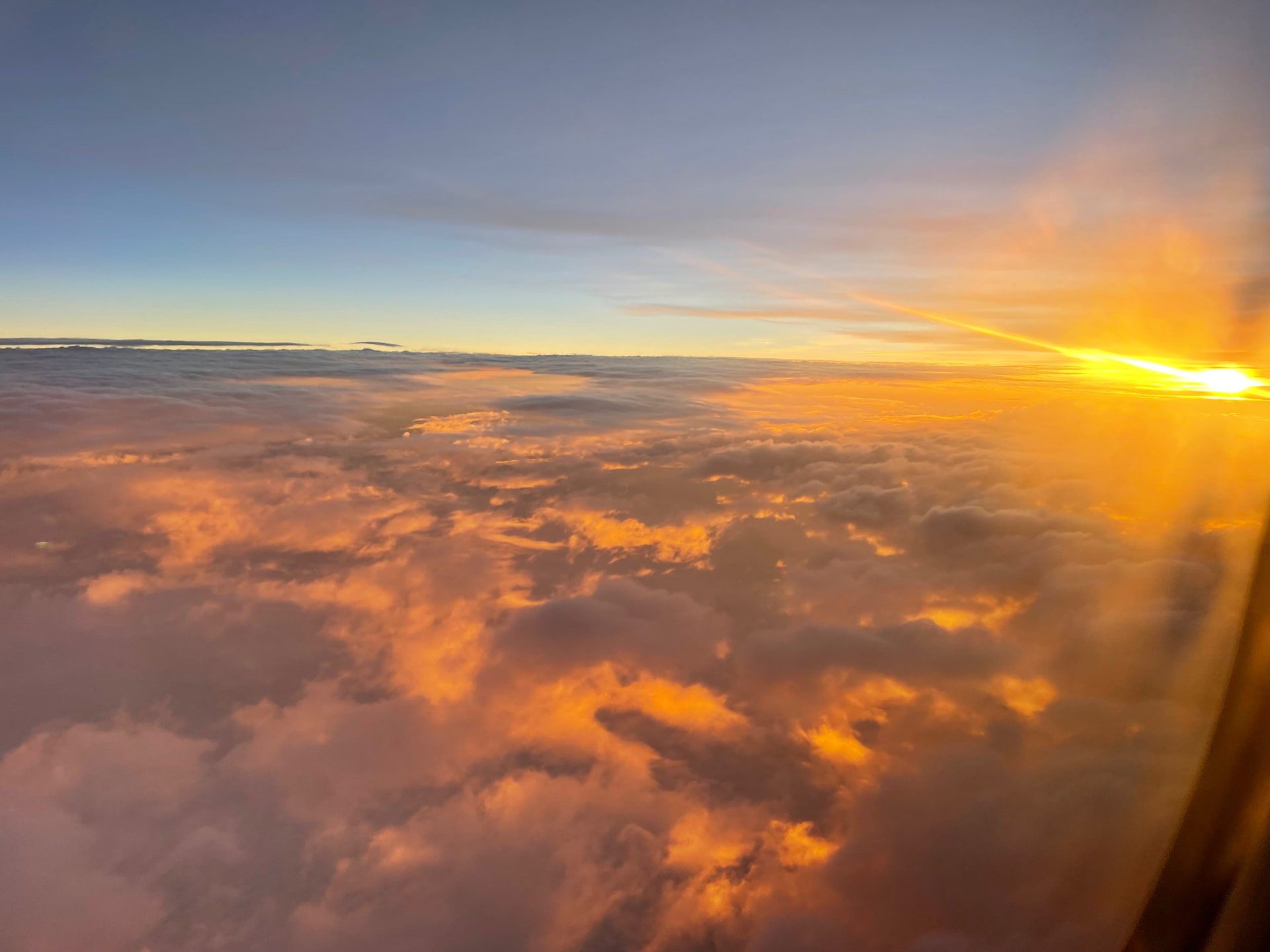 Sunrise above the clouds seen from altitude